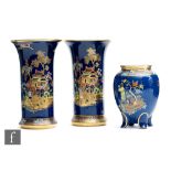 A pair of Carlton Ware trumpet vases decorated in the New Mikado pattern against a blue ground,
