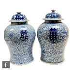 A pair of Chinese late Qing Dynasty (1644-1912), blue and white marriage jars, each of baluster form