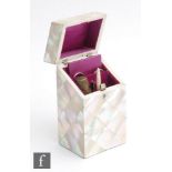 A mother of pearl etui, the rectangular body below sloping hinged lid opening to purple silk lined