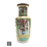 A late 19th Century Chinese Canton famille rose baluster vase, the body painted with panels filled