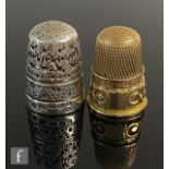 A 9ct hallmarked thimble with a scroll decorated border, weight 5.5g, Birmingham 1901, with a silver