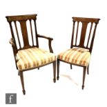 A set of eight early 20th Century mahogany dining chairs with line inlaid and painted foliate