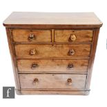 A Victorian mahogany veneered chest of two short over three long drawers, with turned handles
