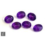 Six loose cut and polished oval amethyst stones each approximately length 12mm, width 10mm, depth