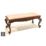 A Victorian rosewood duet music stool of rectangular form, with lift up seat over scroll carved