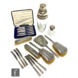 A hallmarked silver backed five piece brush set with engine turned decoration, Birmingham 1932, with