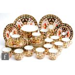 An early 20th Century Royal Crown Derby part teaset comprising twelve cups, twelve saucers, twelve