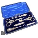 An early 20th Century cased hallmarked silver composed eight piece sewing set, two scissors,
