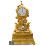 A late 19th century French gilt mantle clock, the circular white enamelled dial with eight day