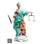 A late 18th to early 19th Century Derby figure modelled as Justice stood in a burnt orange and