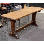 A 20th Century oak refectory table, the rectangular top above carved trestle ends united by a single