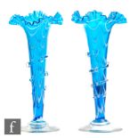 A pair of late 19th Century Stourbridge glass posy vases of footed trumpet form with frill rim,