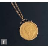 A South African full Krugerrand dated 1981, loose mounted to a 9ct mount and suspended form a 9ct