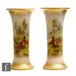 A pair of Royal Worcester shape G923 trumpet vases panel decorated by James Stinton with hand