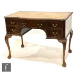 An Edwardian mahogany serpentine Chippendale style kneehole desk, fitted with five drawers below a