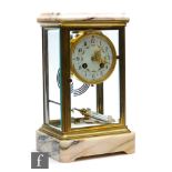 An Edwardian brass mantle clock with mercury suspended pendulum and floral dial, eight day