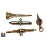Four gilt metal and silver watch keys to include two stone set examples and one modelled as a T bar,