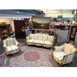 A 20th Century carved gilt wood three piece suite comprising a three seater sofa, length 200cm,