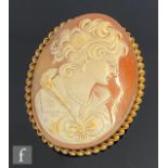 A modern 9ct hallmarked mounted oval cameo brooch depicting a head and shoulder profile of a young