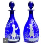 A pair of 20th Century Bristol Blue decanters of mallet form, hand enamelled in the Mary Gregory