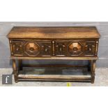 A 17th Century style oak dresser base, the plank top over a projecting geometric moulded front,