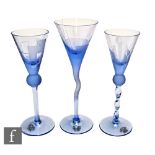 A trio of hand made cocktail glasses by Astera Design with conical bowls raised to variant stems
