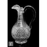 A 19th Century Anglo-Irish clear crystal glass claret jug, the swollen ovoid body with a
