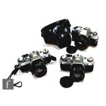 A collection of cameras, to include a Canon AE-1 with Canon 50mm 1:1.8 lens serial number 4174527,