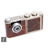 A 1950s West German 'Petie' vanity camera, brown marble leather with chrome hardware, the push