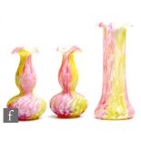 A late 19th Century 'Cottage' glass garniture with a central tall sleeve vase and a pair of