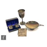 Four items of hallmarked silver a goblet, a twin handled pedestal dish a cigarette box and a cased