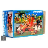 A Playmobil 3147 red race car and crew, boxed.