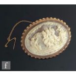 A modern 9ct mounted oval cameo brooch depicting the three graces in a landscape setting, total