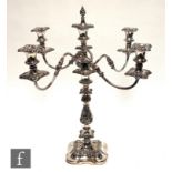 An early 20th Century silver plated five light candelabra, shaped square base rising to four