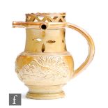 An early 19th Century Derbyshire salt glazed brown stoneware puzzle jug, probably Brampton, the