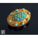 A late 19th Century 15ct oval brooch set with central paste within a turquoise cluster and a further