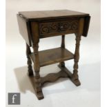 A small 17th Century style carved oak drop flap table, possibly by Titchmarsh and Goodwin, single