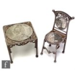 A hallmarked silver novelty miniature table and chair each set with a Victorian coin, height of