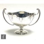 An Art Nouveau hallmarked silver twin handled pedestal bowl detailed with leaf decoration to border,