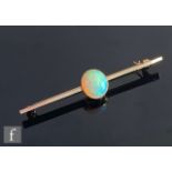 An early 20th Century single stone opal brooch, oval collar set stone length approximately 10mm,