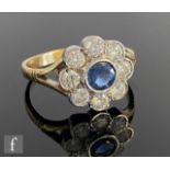A 9ct hallmarked sapphire and diamond daisy cluster ring, central collar set sapphire within an