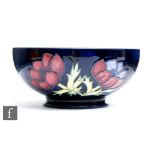 A Moorcroft Pottery footed bowl decorated in the Anemone pattern with tubelined flowers to the