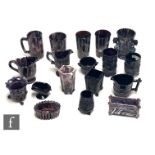 A collection of 19th Century North Counties pressed glasses posy vase and cream jugs in black and