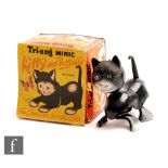 A Triang Minic Kitty and Butterfly clockwork plastic toy, formed as a black and white cat with a