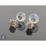 A pair of platinum diamond solitaire stud earrings, claw set brilliant cut stones, total weight 0.