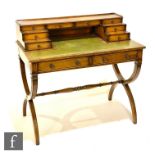 Amended description - A late 20th Century walnut veneered writing desk in the Regency style,