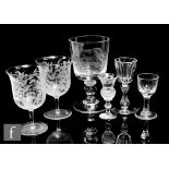 A pair of late 19th Century acid etched wine glasses of swollen bell form, decorated with the