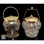 A late 19th Century pressed clear crystal glass biscuit barrel of footed shouldered form with a