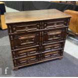 An 17th Century style oak geometric moulded oak chest of two short and three long drawers, applied