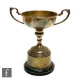 A hallmarked silver twin handled trophy cup to a plinth base, weight of cup 4.5oz, engraved,